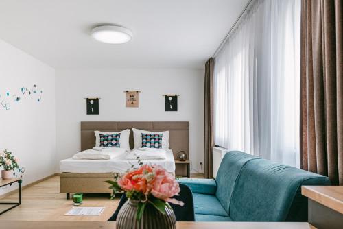 a hotel room with a bed and a couch at Jarila Boutique Apartment in Bratislava