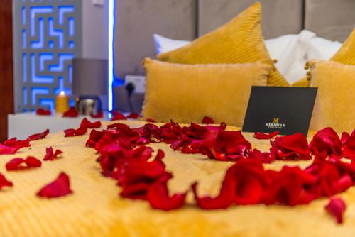 a cake with red roses on top of it at Meridian Serviced Apartments in Bradford