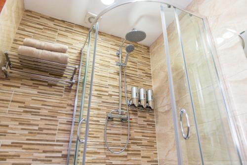 a bathroom with a shower with a glass door at Meridian Serviced Apartments in Bradford
