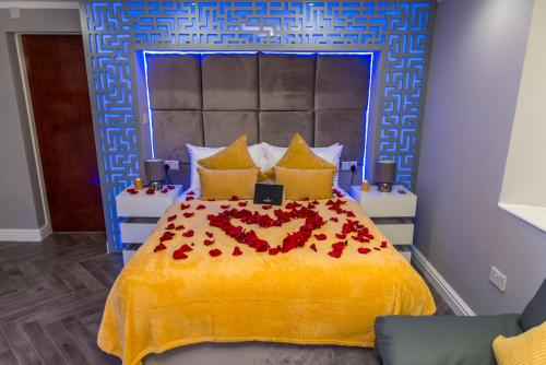 a bedroom with a bed with a heart made out of roses at Meridian Serviced Apartments in Bradford