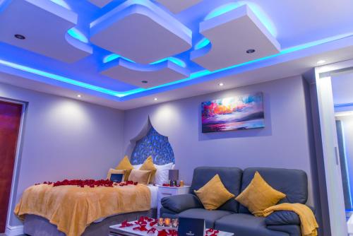 a bedroom with a bed and a couch and lights at Meridian Serviced Apartments in Bradford