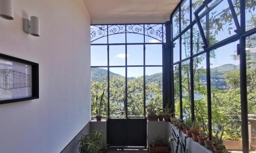 a room with a large window with plants at Veranda lake view in Como