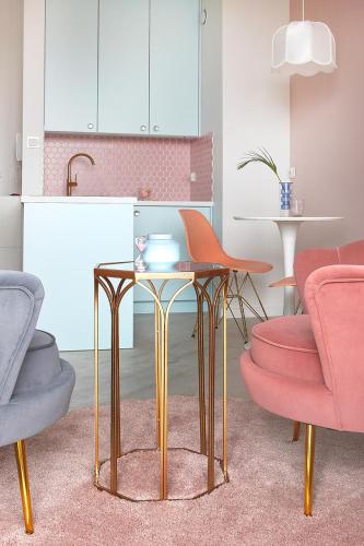 a living room with two chairs and a table at ParkCity Katowice in Katowice