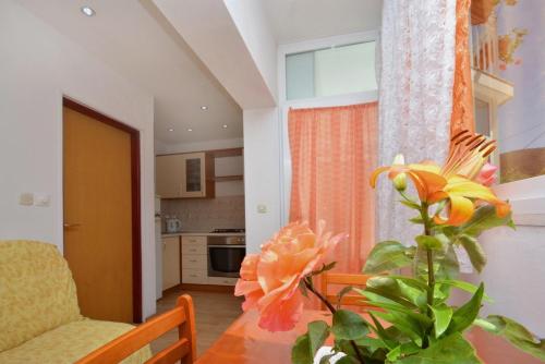 a living room with a table with a flower on it at Apartment with large terrace 3558-4 in Žuljana