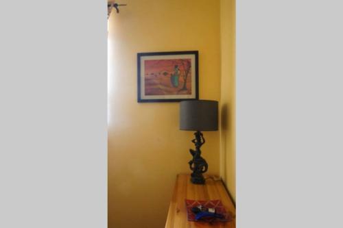una lámpara sentada en una mesa en una habitación en Private room in Shared apartment close to University of Malta & Mater Dei en Birkirkara
