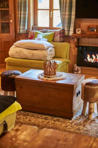 a living room with a table and a fireplace at Appartement Gretl in Viehhofen