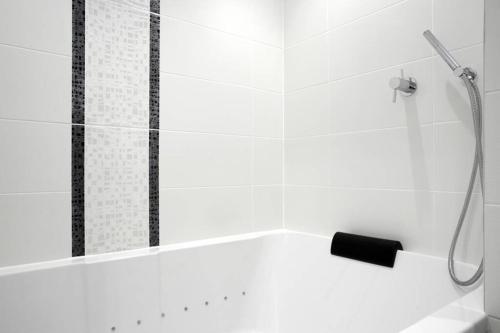 a bathroom with a shower with a black and white at Turtle Apartment in Edinburgh