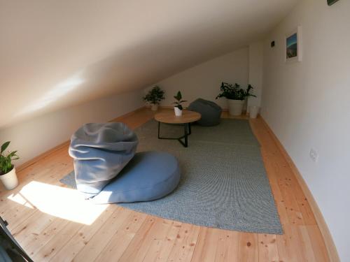 a living room with a blue bean bag chair and a table at Gavan Apartment in Cres