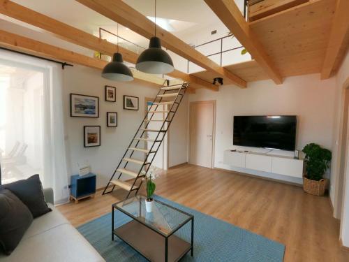 a living room with a ladder and a flat screen tv at Gavan Apartment in Cres