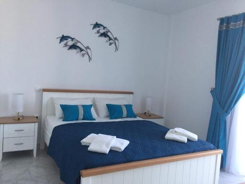 Ένα ή περισσότερα κρεβάτια σε δωμάτιο στο ILIOPOULOS Apartments