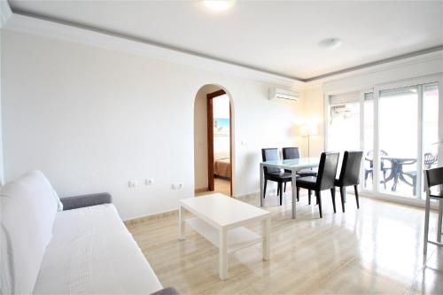 a living room with a table and chairs at Spanish Connection - Seychelles in La Manga del Mar Menor