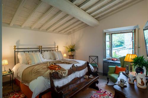 a bedroom with a large bed with a wooden frame at Castello di Volpaia in Radda in Chianti