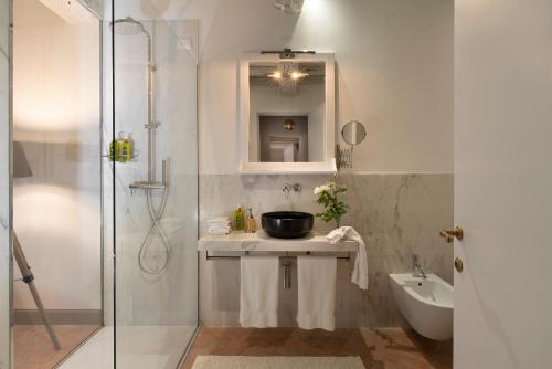 a bathroom with a sink and a shower at Castello di Volpaia in Radda in Chianti