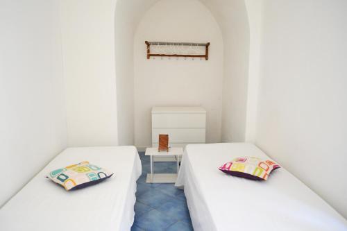 En eller flere senger på et rom på Le case di Nina