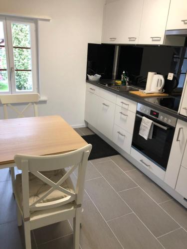 a kitchen with a wooden table and a table and a stove at Villa Matten in Matten