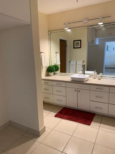 a bathroom with a sink and a large mirror at Sweet Serenity St Croix USVI in Christiansted