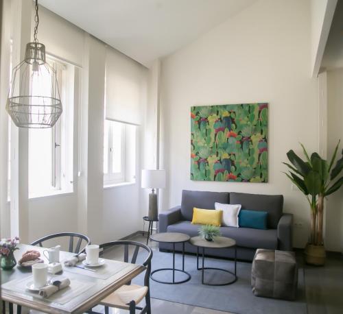 a living room with a couch and a table at Casa Chinitas Holiday Homes in Málaga