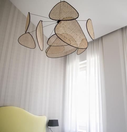 a room with a yellow chair and a chandelier at Casa Chinitas Holiday Homes in Málaga