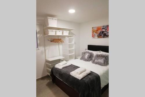 a bedroom with a bed with white shelves at M1 Cool Loft 1 min walk to metro 15 min center by metro in Esplugues de Llobregat
