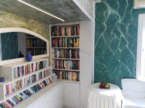 a room with two book shelves filled with books at KORIFI Adults Only in Hersonissos