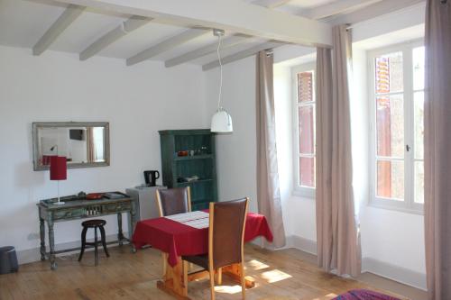 a dining room with a table and a desk at Castel Rouge in Luzech