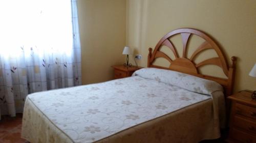 A bed or beds in a room at Apartamentos Carolina
