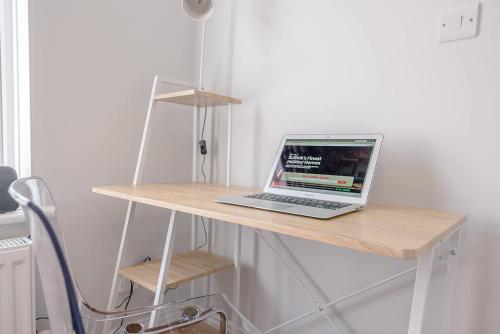 a laptop computer sitting on top of a wooden desk at The Grange, Aldeburgh in Aldeburgh