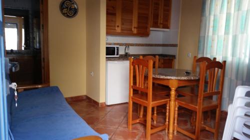 een keuken met een tafel en stoelen in een kamer bij Apartamentos Carolina in San José