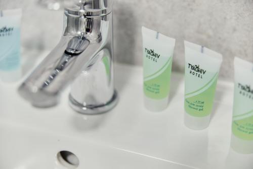 a bathroom sink with a toothbrush and a bottle of toothpaste at готель Тячів in Tyachiv