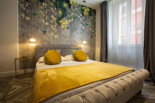 a bedroom with a bed with a yellow blanket at La Terrazza Antica Dimora in Campobasso