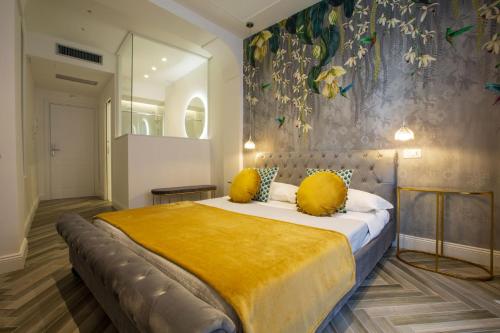 a bedroom with a large bed with yellow pillows at La Terrazza Antica Dimora in Campobasso