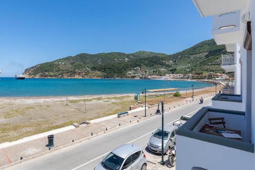 a view of a road and a beach from a building at Uncle John's Guesthouse in Skopelos Town