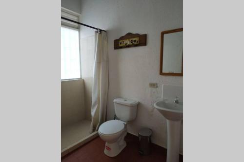 a bathroom with a toilet and a sink at Casa de campo con hermosa vista in Anapoima