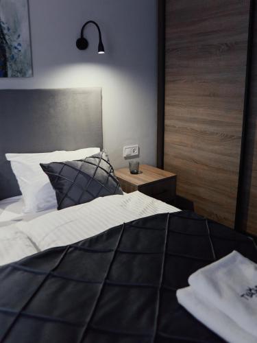 a bedroom with a large bed and a night stand at готель Тячів in Tyachiv