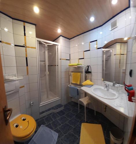 a bathroom with a toilet and a sink and a shower at Smile Hotel in Nuremberg