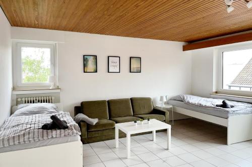 a living room with a couch and a bed at Schöne 3 Zimmerwohnung in Düren in Düren - Eifel