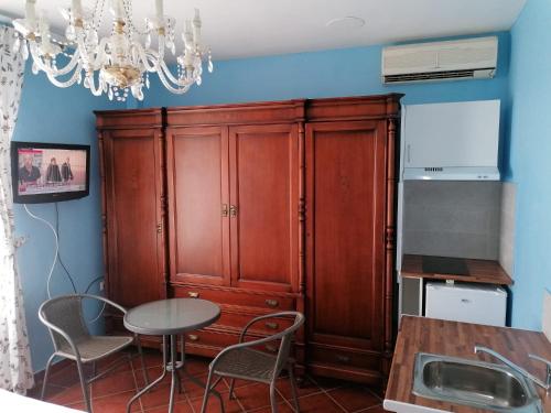 a large wooden cabinet in a kitchen with a table at Casa Cabo de Gata in Retamar