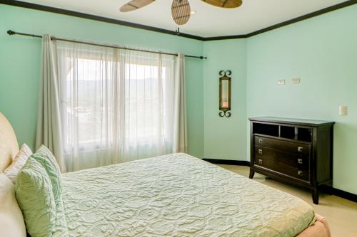 a bedroom with a bed and a dresser and a window at Diamante del Sol 602N in Jacó