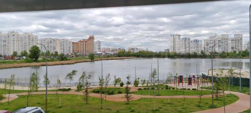 a view of a river with a playground in a city at Apartments Swan Lake in Kyiv