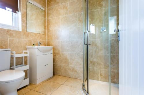 a bathroom with a shower and a toilet at The Vale Golf & Country Club in Bishampton