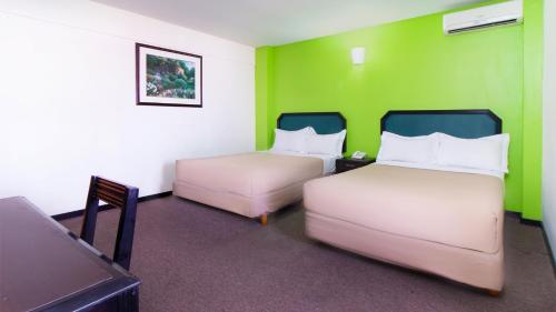 Postel nebo postele na pokoji v ubytování CHN Hotel Monterrey Santa Fe