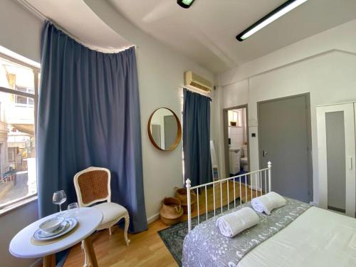 1 dormitorio con cama, mesa y espejo en Unique Studios Phaneromenis 41 - Down Town Nicosia en Nicosia