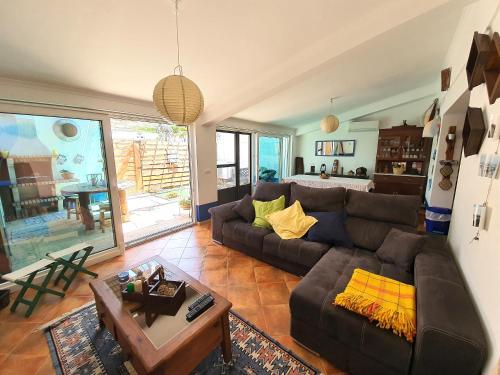 a living room with a couch and a table at Comporta Family House in Comporta