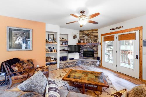a living room with a ceiling fan and a fireplace at Black Diamond #1B in Vista