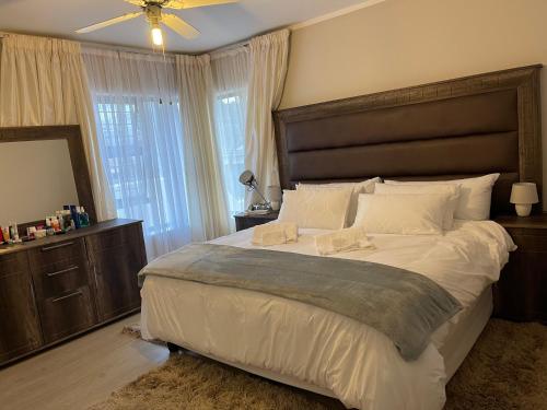 A bed or beds in a room at Jackie’s 3 bedroomed secure beach front apartment Strand Golden Mile 