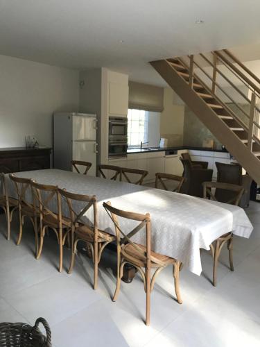 um quarto com uma mesa e cadeiras e uma cozinha em Oscaar vakantiewoning in bos em Koekelare