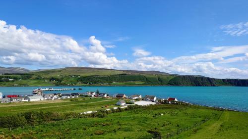 a view of a large body of water with a village at Uig Chalets Idrigill Hill Chalet in Uig
