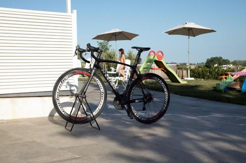 a bike parked on a stand next to a playground at Residence Borgo Offida in Offida