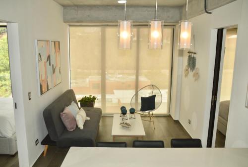 a living room with a couch and a table at Cozy Stays Cayala Apartments 5 in Guatemala