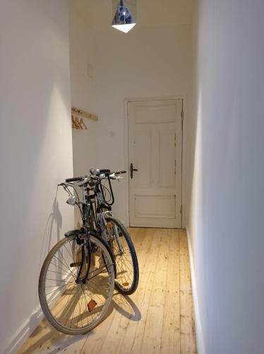 two bikes parked against a wall in a room at Old Town Apartment in Cēsis